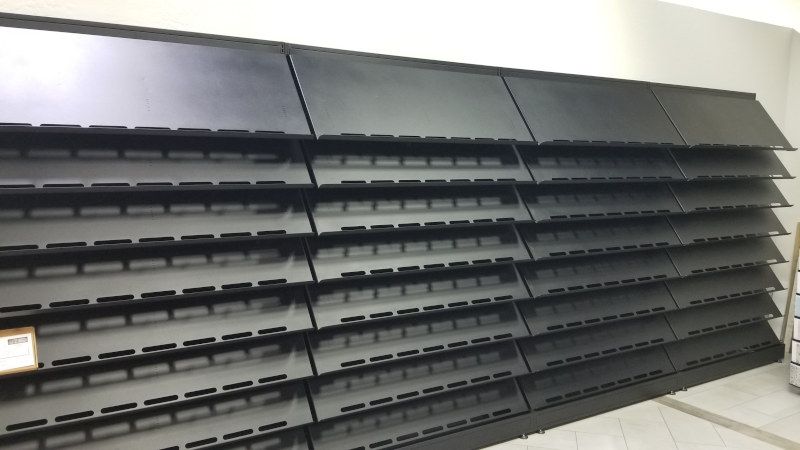 Custom tile sample rack with angled shelving by Creative Display Works for Mariano Tile